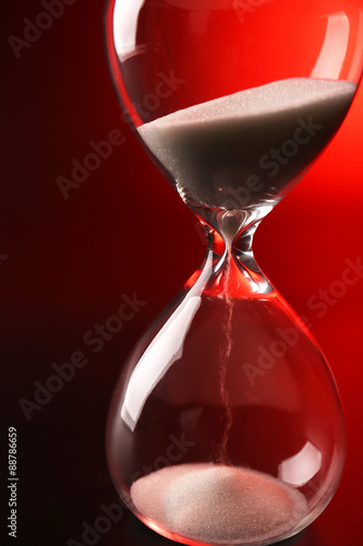 Hourglass on dark red background