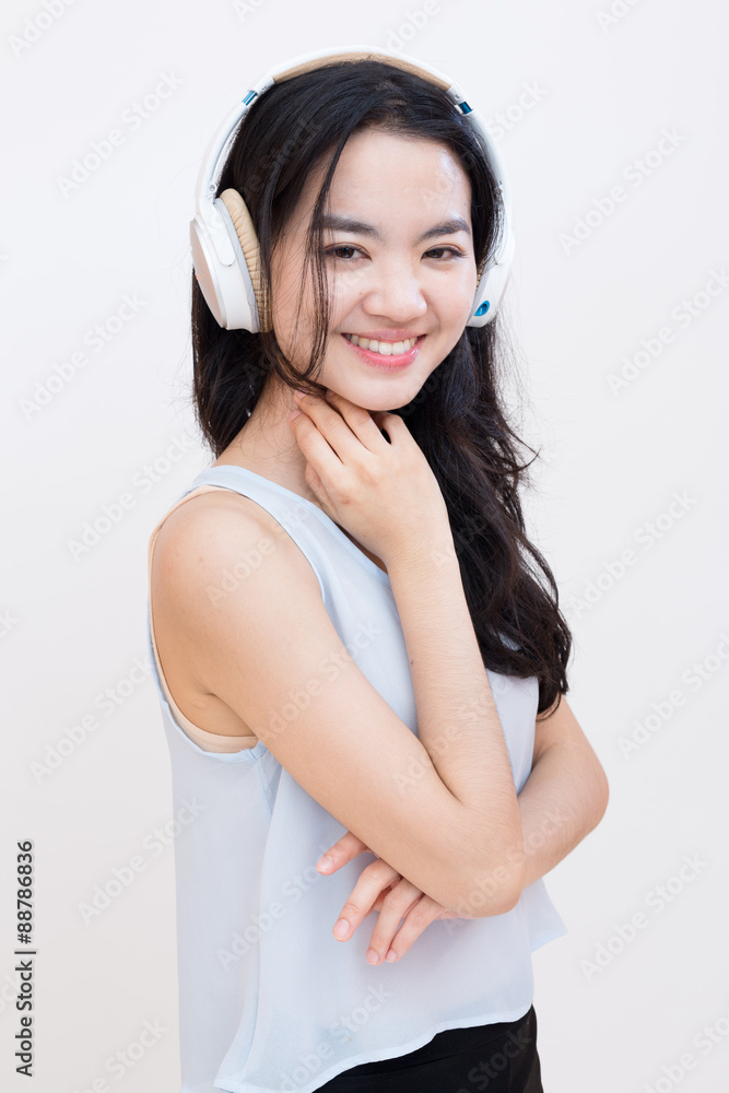 Young asian student enjoying music in casual clothes Young asian student enjoying music in casual clothes