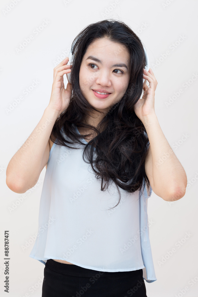 Young asian student enjoying music in casual clothes Young asian student enjoying music in casual clothes
