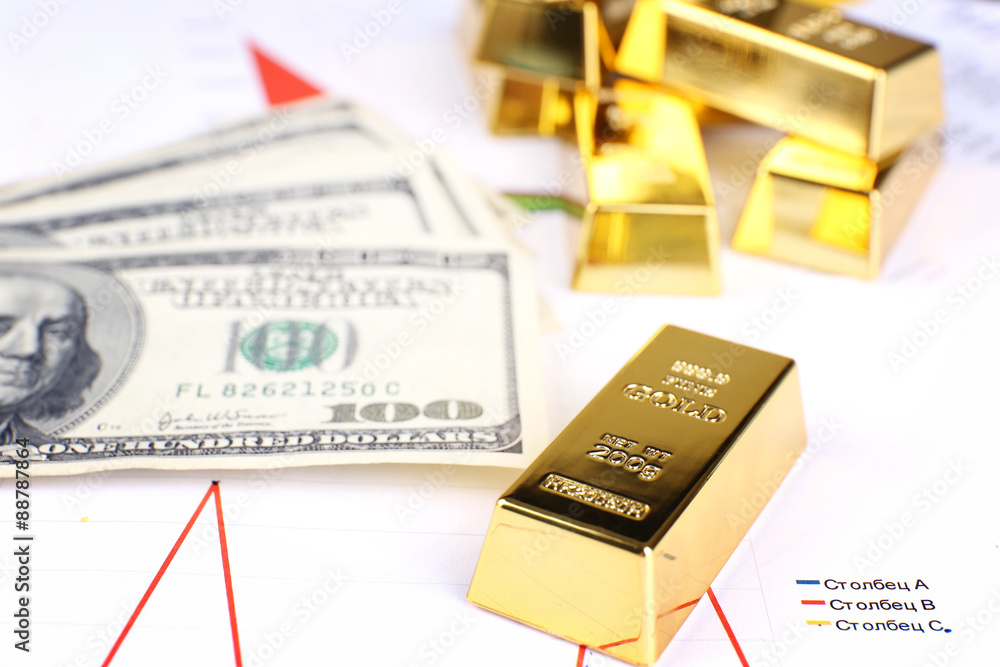Gold bullion with money on table close up Gold bullion with money on table close up