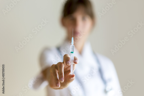 Nurse holding an injection needle photo