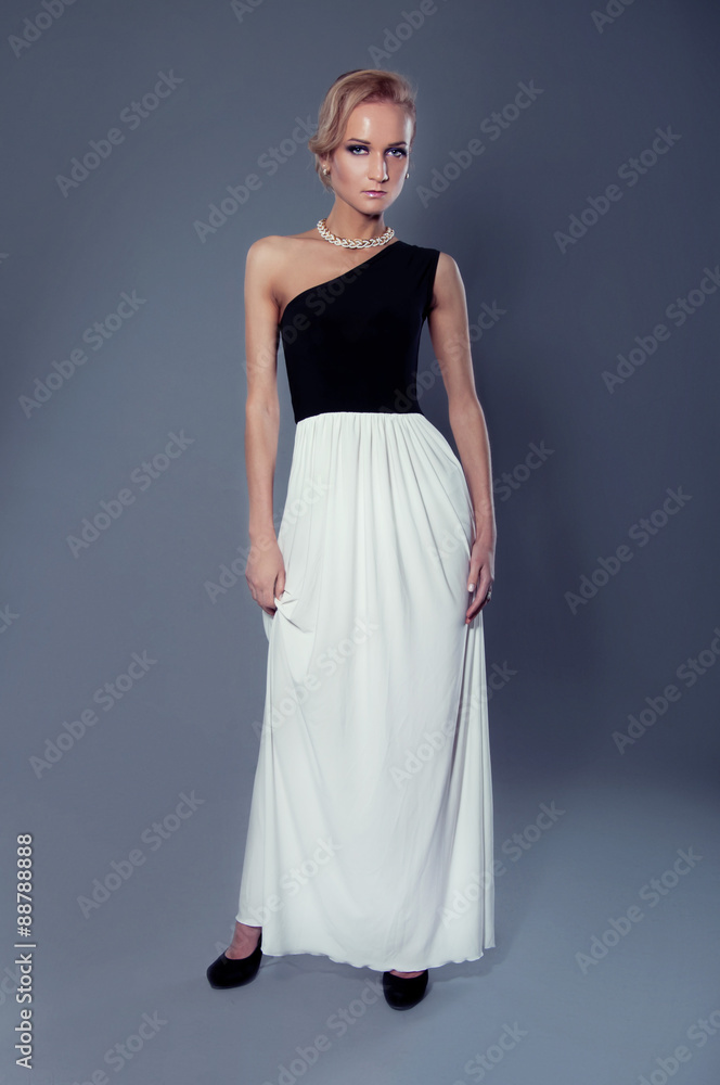 Studio portrait of beautiful blonde woman in elegant black and w