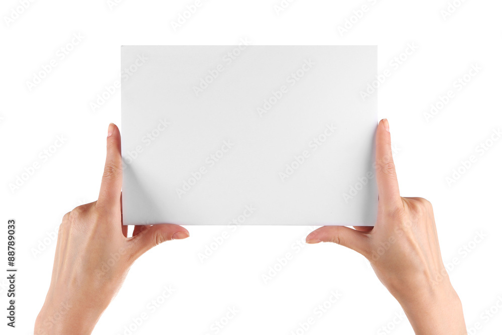 Female hand holding paper blank isolated on white Female hand holding paper blank isolated on white