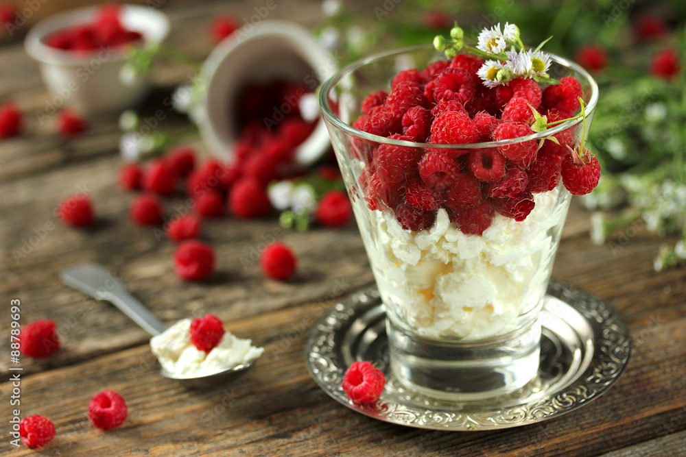 Healthy breakfast: fresh cheese with raspberries in a glass Healthy breakfast: fresh cheese with raspberries in a glass