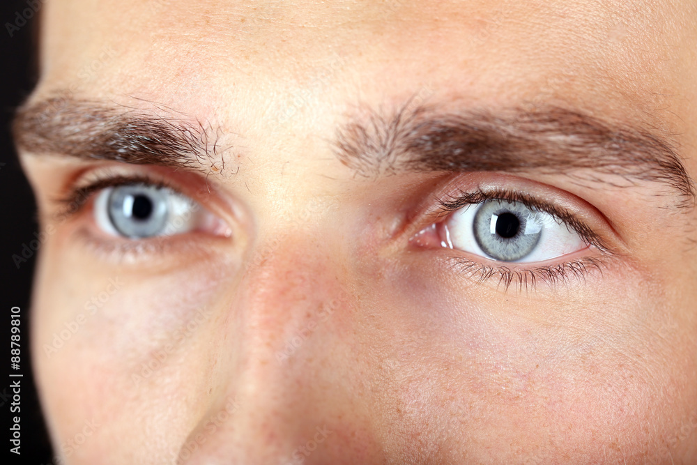 Fototapeta premium Beautiful blue man eyes close up