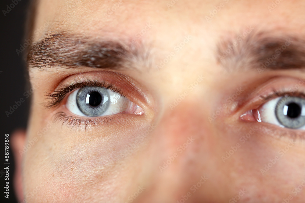 Fototapeta premium Beautiful blue man eyes close up