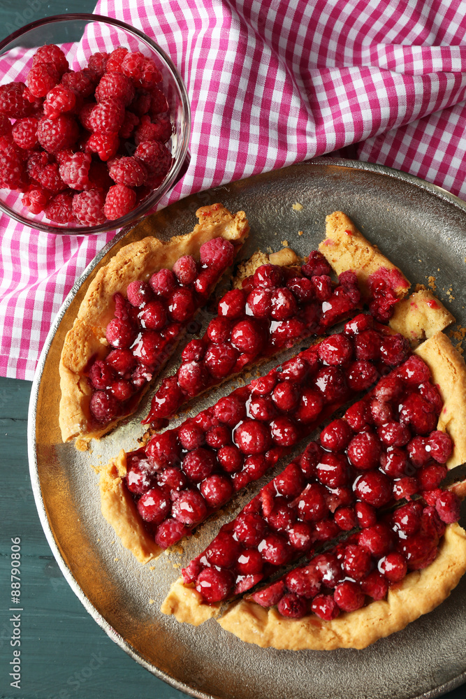 Tart with raspberries on tray, on wooden background Tart with raspberries on tray, on wooden background