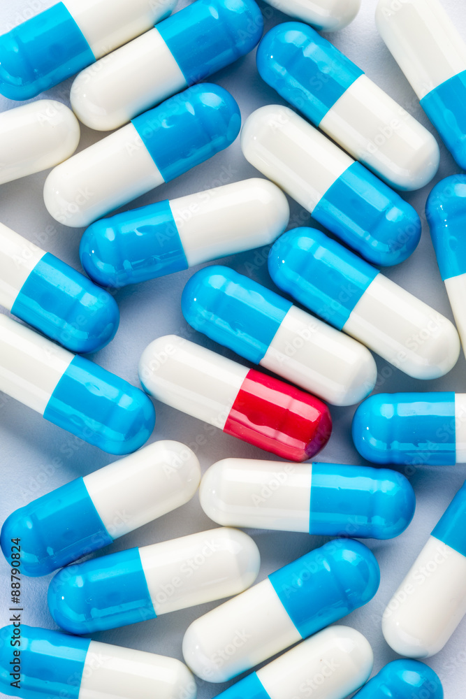 blue capsules and red capsules, medication cure close up blue capsules and red capsules, medication cure close up