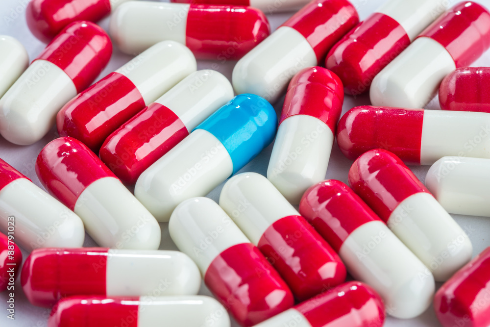 blue capsules and red capsules, medication cure close up blue capsules and red capsules, medication cure close up