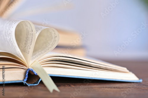 Pages of book curved into heart shape, close up