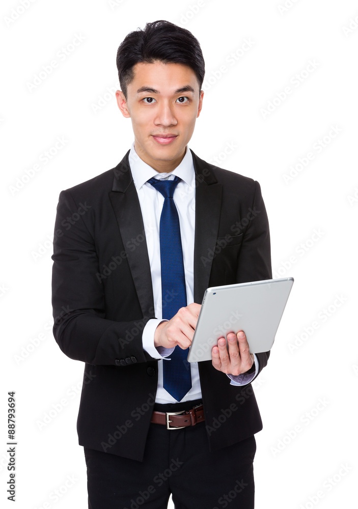 Asian Young Businessman use of the tablet pc Asian Young Businessman use of the tablet pc