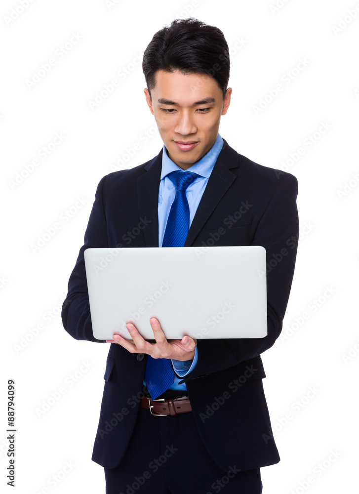 Asian businessman use of the notebook computer Asian businessman use of the notebook computer