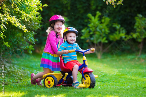 Two children riding bikes photo
