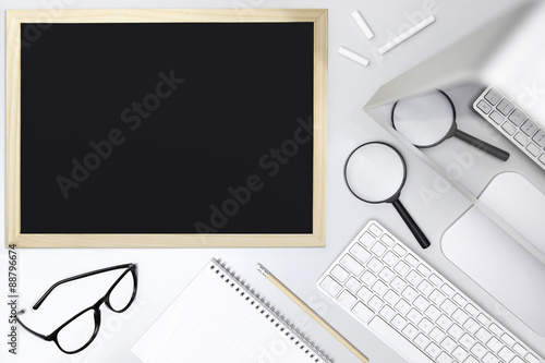 desk school concept, blackboard, magnifying and computer, top view