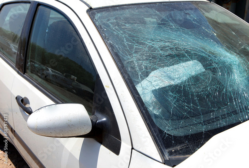 White car with smashed windshield