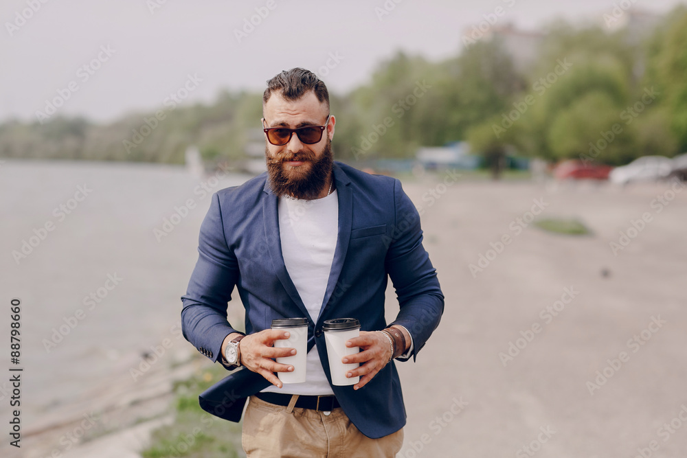 Fototapeta premium bearded man carrying coffee