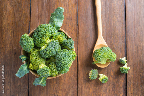 Raw broccoli on wooden background photo