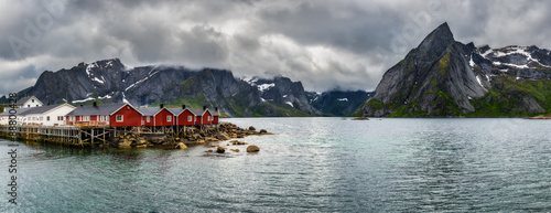 Mount Olstind above red fishing cabins in Hamnoy, Norway #88800428