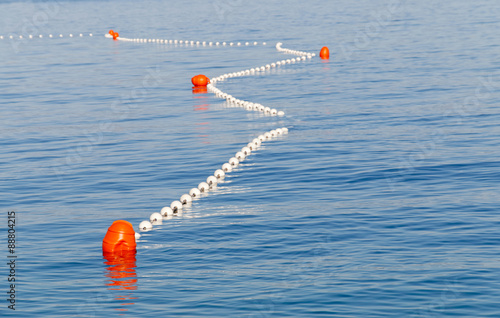 Red markers in the sea marking the safe swimming area