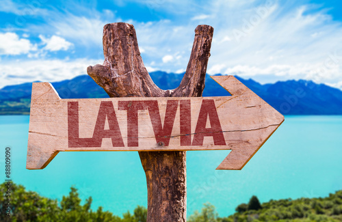 Latvia wooden sign with river on background photo
