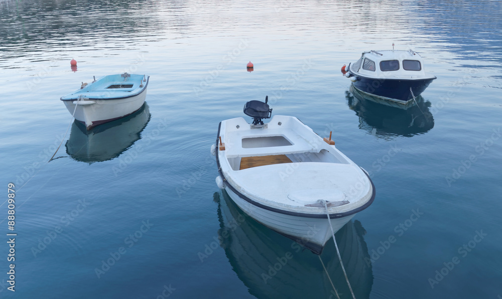 Three small fishing boat in calm water