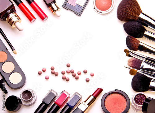 Set of professional cosmetic: make-up brushes, shadows, lipstick, nail polishes - partly isolated with shadows on white background. Overhead view. Front part. Place for your text.