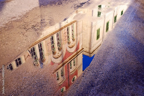 Puddle with a reflection of buildings, Vis island, Croatia. photo