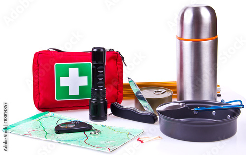 Travel set. Tourist outfit for camping or hiking. Various professional tools and items for outdoors pastime on white background, partly isolated with shadows. Place for your text.