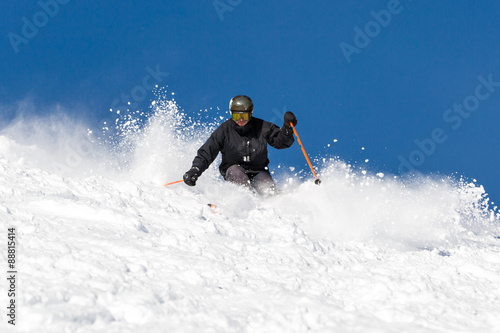 Skier skiing off piste in powder snow