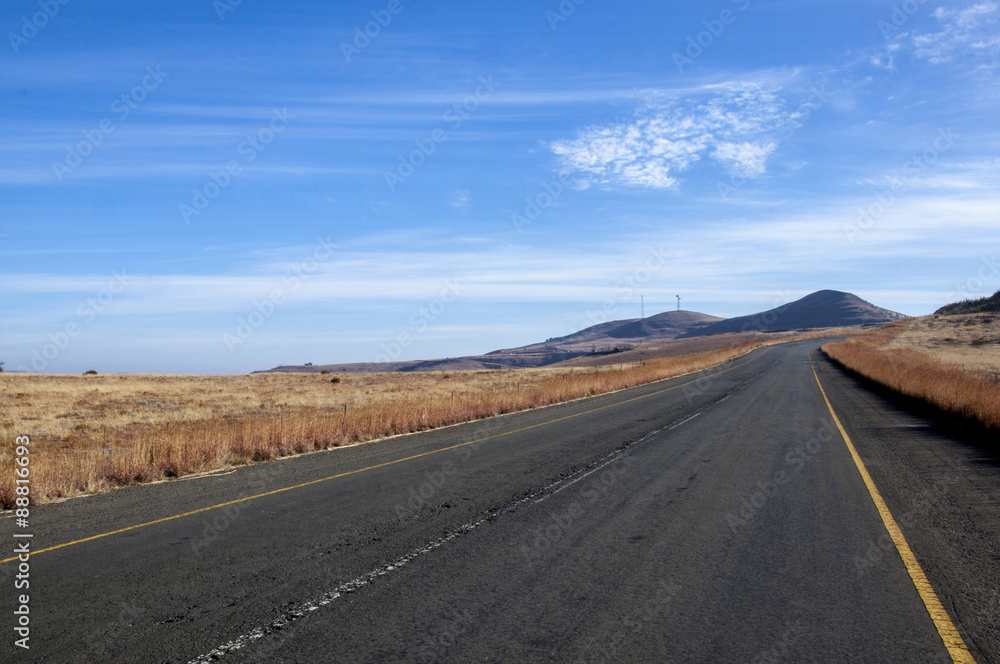 Worn Asphalt Road Heading into the Mountains Worn Asphalt Road Heading into the Mountains