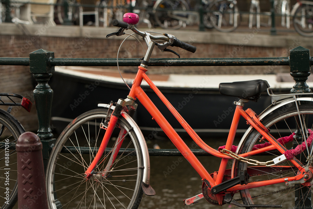 red vintage bike on the street in amsterdam