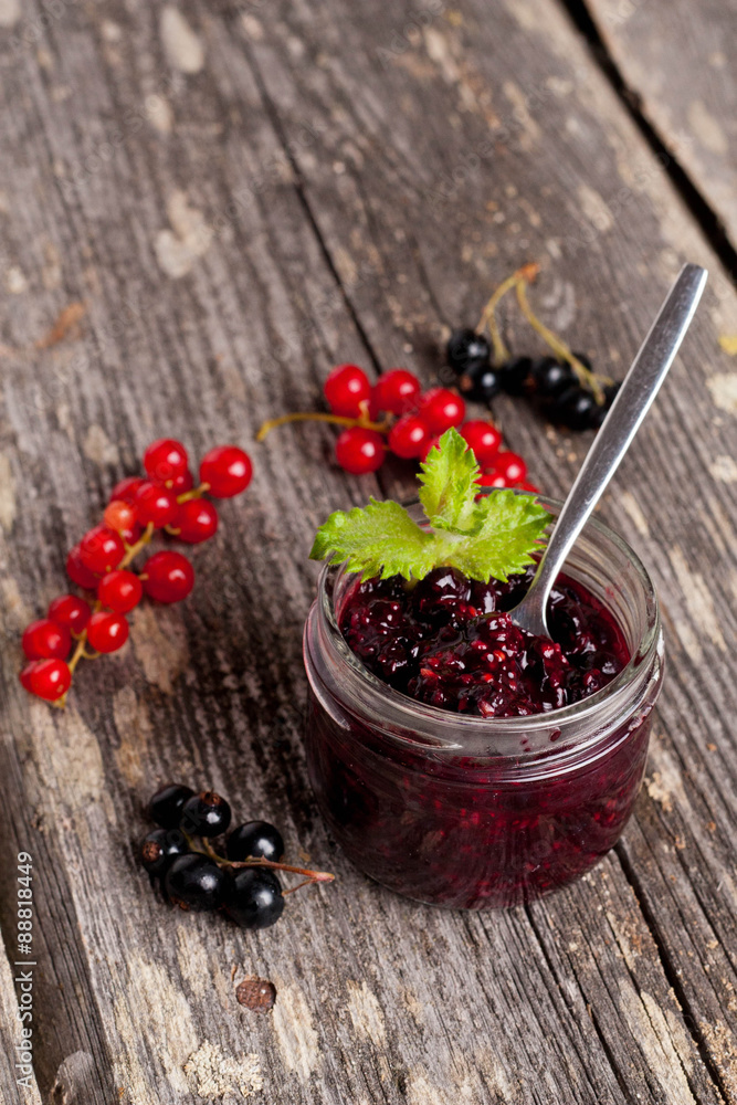 berry jam in a glass jar and fresh red currants on wooden board, berry jam in a glass jar and fresh red currants on wooden board,