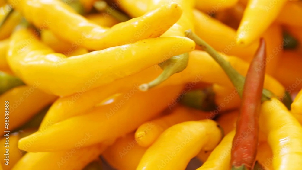 Chili peppers falling down at rotating stand; no people, close up; HD 1080 static; Chili peppers falling down at rotating stand; no people, close up; HD 1080 static;