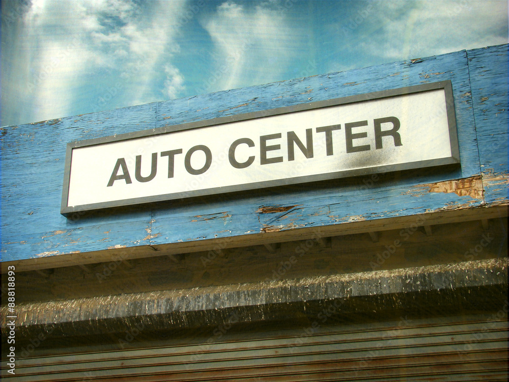 aged and worn vintage photo of auto center sign