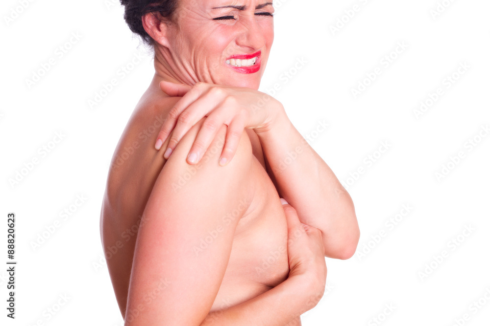 Fototapeta premium Frau mit schmerzverzehrten Gesicht, hält sich die Schulter 