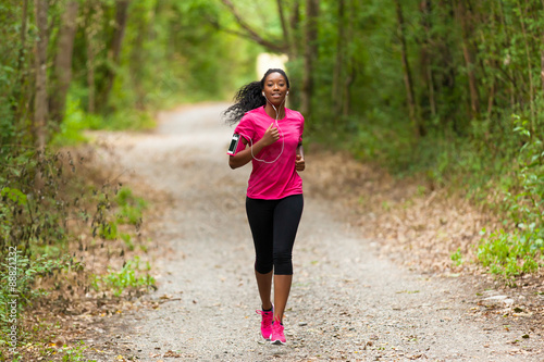 Fototapeta Naklejka Na Ścianę i Meble -   African american woman runner jogging outdoors - Fitness, peopl
