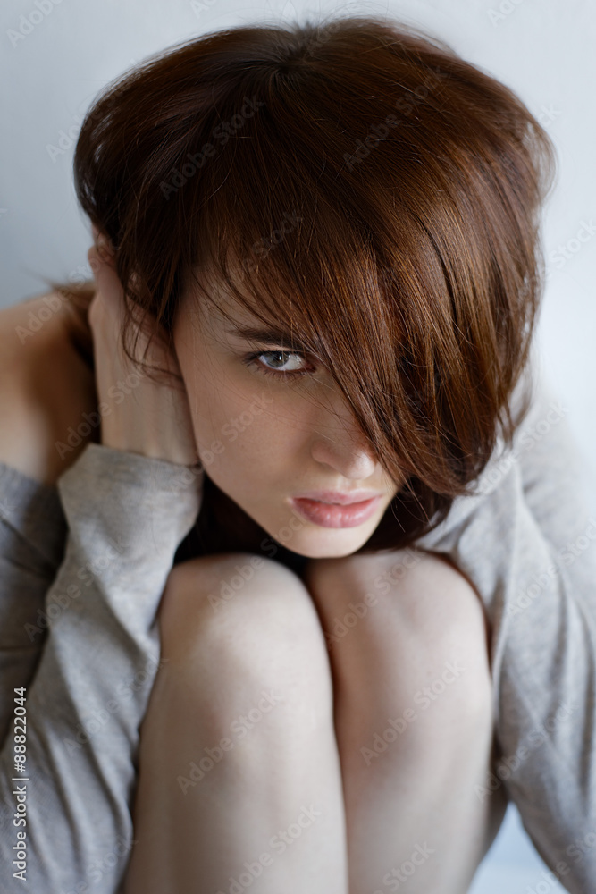 Close-up of a depressed woman deep in thought outdoors. Close-up of a depressed woman deep in thought outdoors.