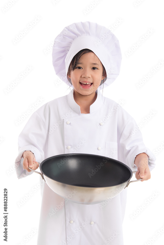 Little asian girl in chef uniform holding the frying pan,isolated on white Little asian girl in chef uniform holding the frying pan,isolated on white
