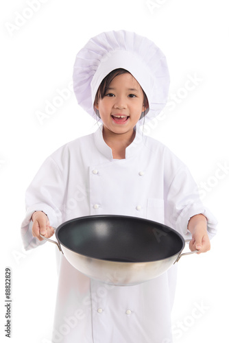 Little asian girl in chef uniform holding the frying pan,isolated on white