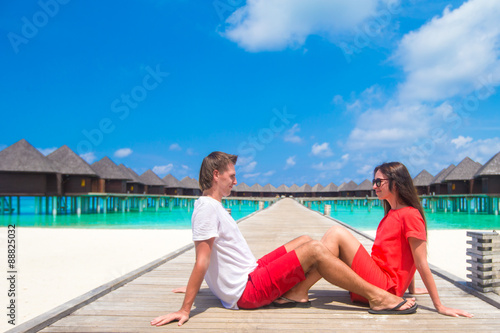 Young happy couple in red during tropical beach vacation