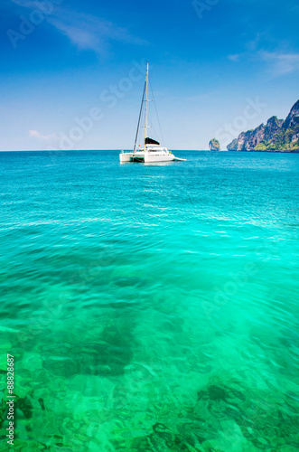 Seascape with sailboat the background of the blue sky. © martinhosmat083