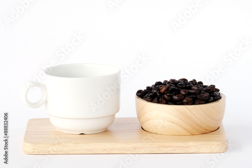 Coffee beans in wood bowl and coffee cup on wood tray