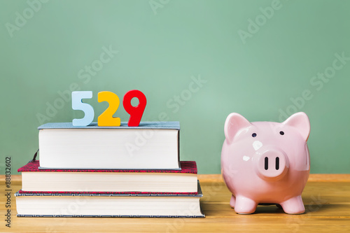 529 college savings plan theme with textbooks and piggy bank photo