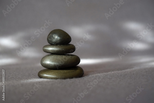 This is a stack of stones against a serene soft gray background.