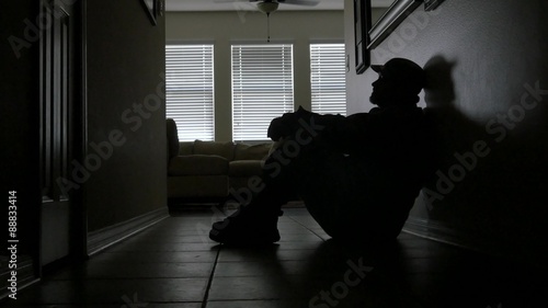 Soldier's silhouette rests against the hallway wall battling PTSD, MEDIUM, 4K