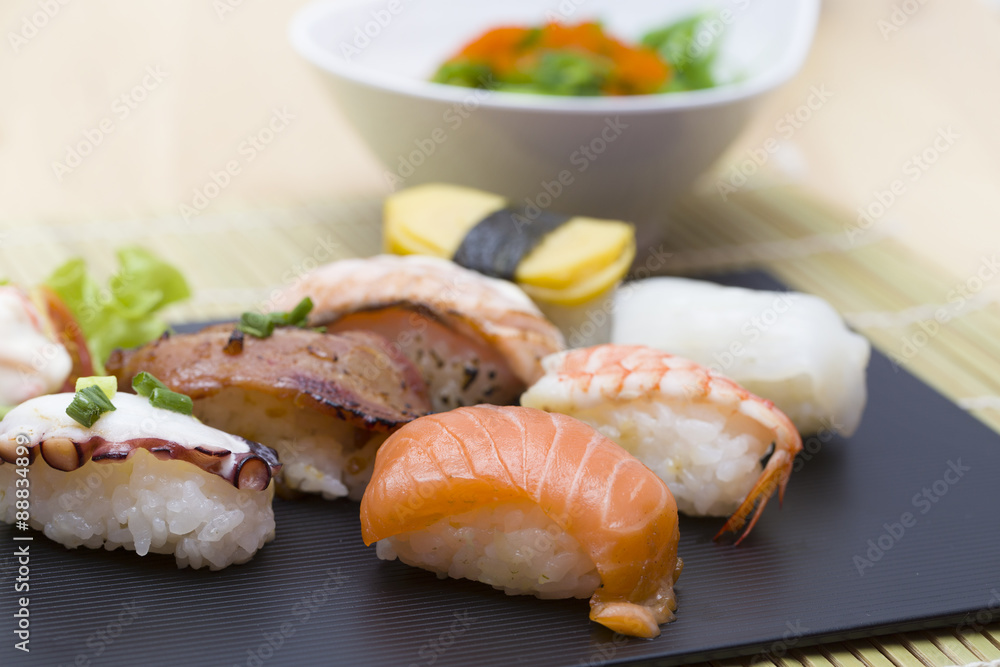 Sushi assortment on black dish, close up Sushi assortment on black dish, close up