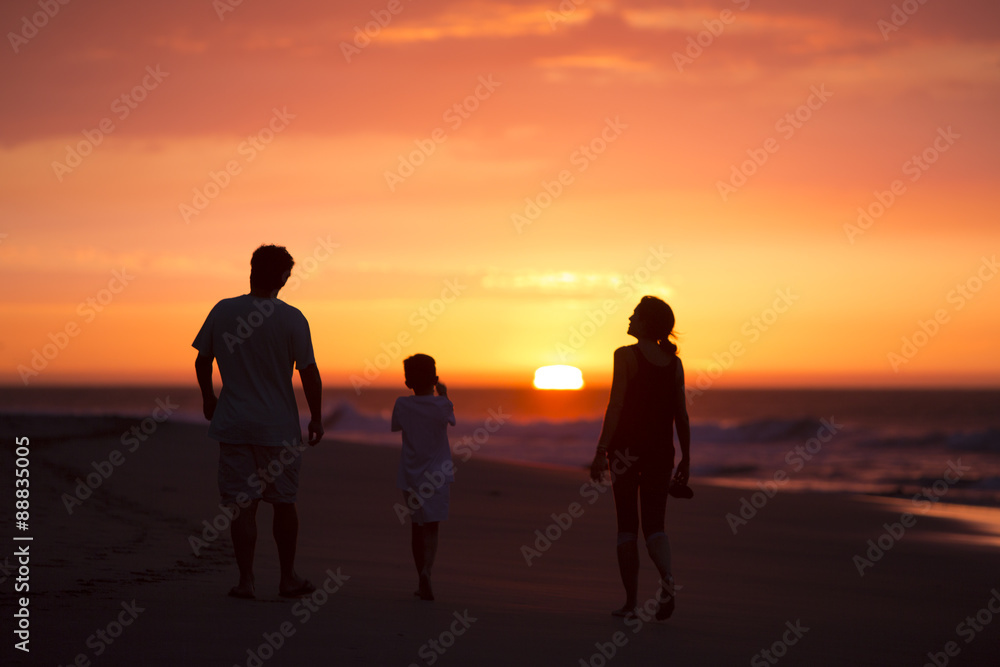 silhouette of family on the beach at dusk in Peru