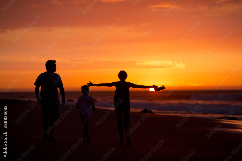 silhouette of family on the beach at dusk in Peru