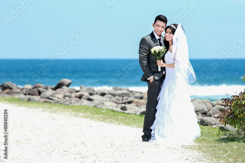happiness of newlywed couple at seashore