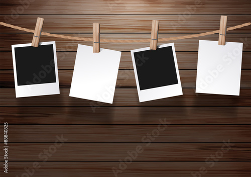 Photos frame hanging on a rope with on old wood background
